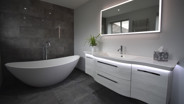 Water's stone freestanding Breeze bath with Contea two drawer vanity unit in oak horizontal effect