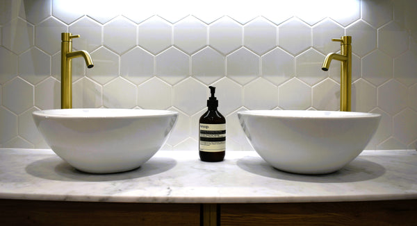 Twin Casteloni sinks with tall basin mixer taps in brushed brass