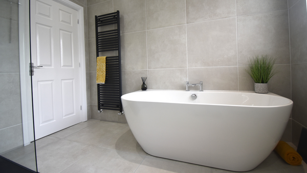 Waters loche back to wall bath on Caya Perla porcelain floor and wall tiles