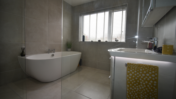 Waters loche back to wall bath on Caya Perla porcelain floor and wall tiles