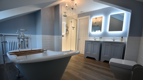 Beaulieu cast iron bath in cornflower blue with claw chrome feet and Tetbury two door sink units in cornflower blue with ceramic basins and hib globe mirrors with led