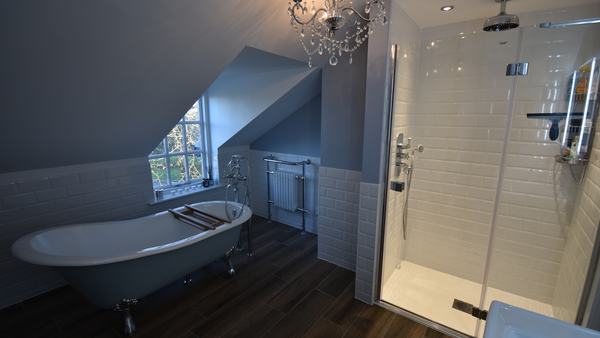 Belgravia freestanding bath and shower mixer in chrome with beaulieu cast iron bath in cornflower blue with claw chrome feet against bevelled brick tiles in white and liberty mocha porcelain floor tiles