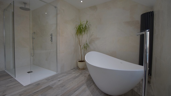 Crosswater walk-in shower with Waters freestanding bath and Chorus vertical tube anthracite radiator