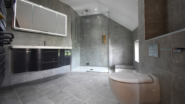 Kudos Pinnacle 8 shower cubicle with inline door and low profile tray, Quantum sunken bath, Pelipal anthracite gloss sink unit.