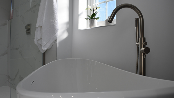 Freestanding bath with MPRO bath and shower mixer in brushed stainless steel effect