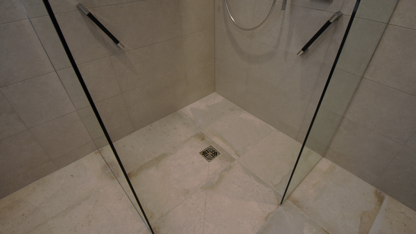 Abacus walk-in-shower panels and countour white floor tiles with chrome grab bars with black grip