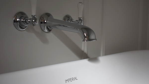 Three hole wall mounted bath filler in chrome with London levers