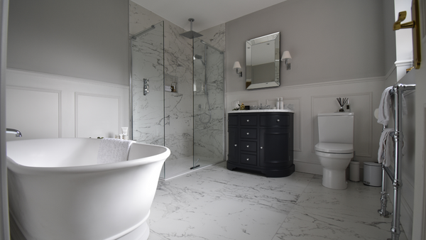 Full bathroom image with freestanding bath and shower enclosure and curved vanity unit