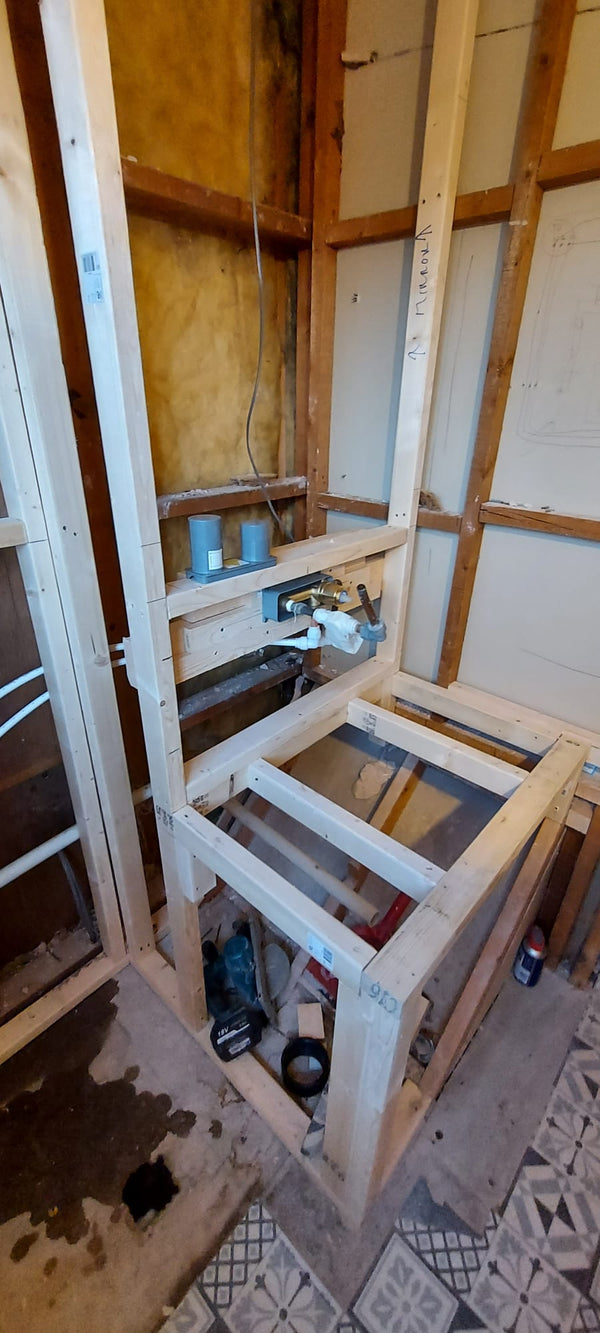 Timber boards outlining a basin for a bathroom installation by The Bathroom Sanctuary.
