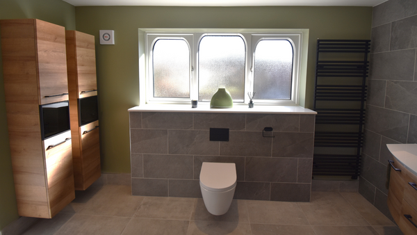 Cilantro wall hung rimless WC on Rock G wall tiles with TT Lux radiator in matt black